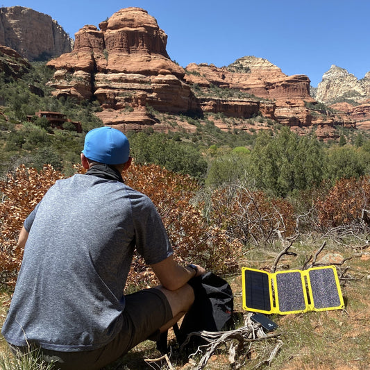 Hiker carrying a SunJack solar panel