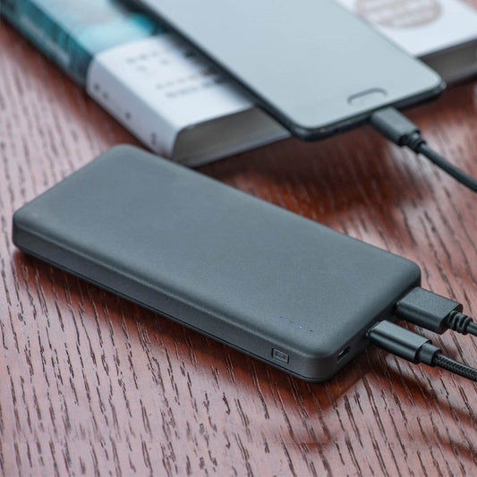 SunJack power bank charging a phone outdoors